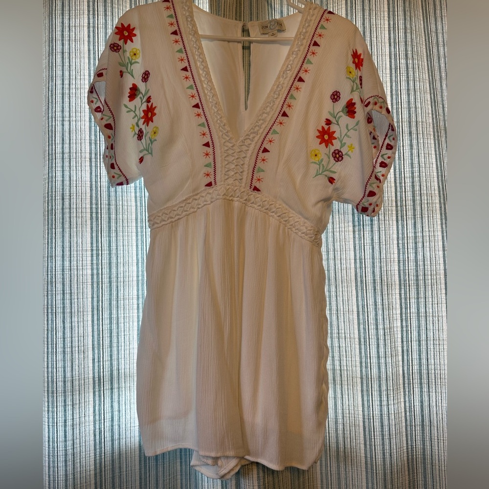 Adorable white romper with colorful detailing!